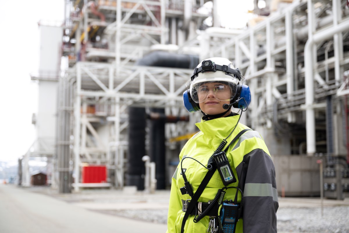Woman with helmet and work clothes