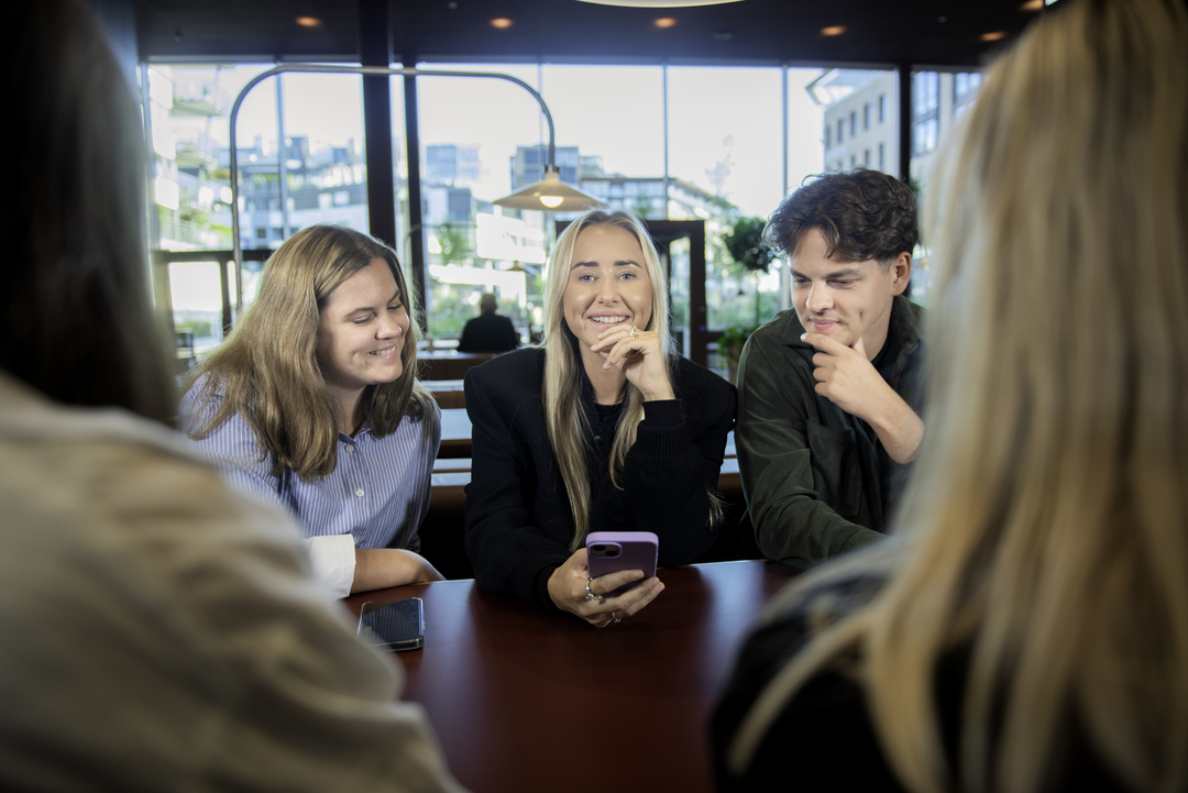 NITO students discuss around a table