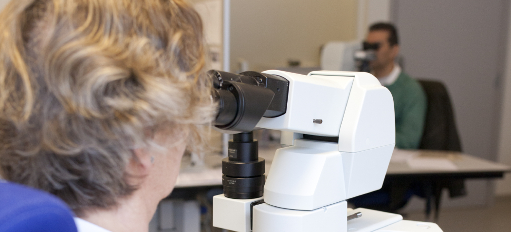 Bioengineer looking into a microscope