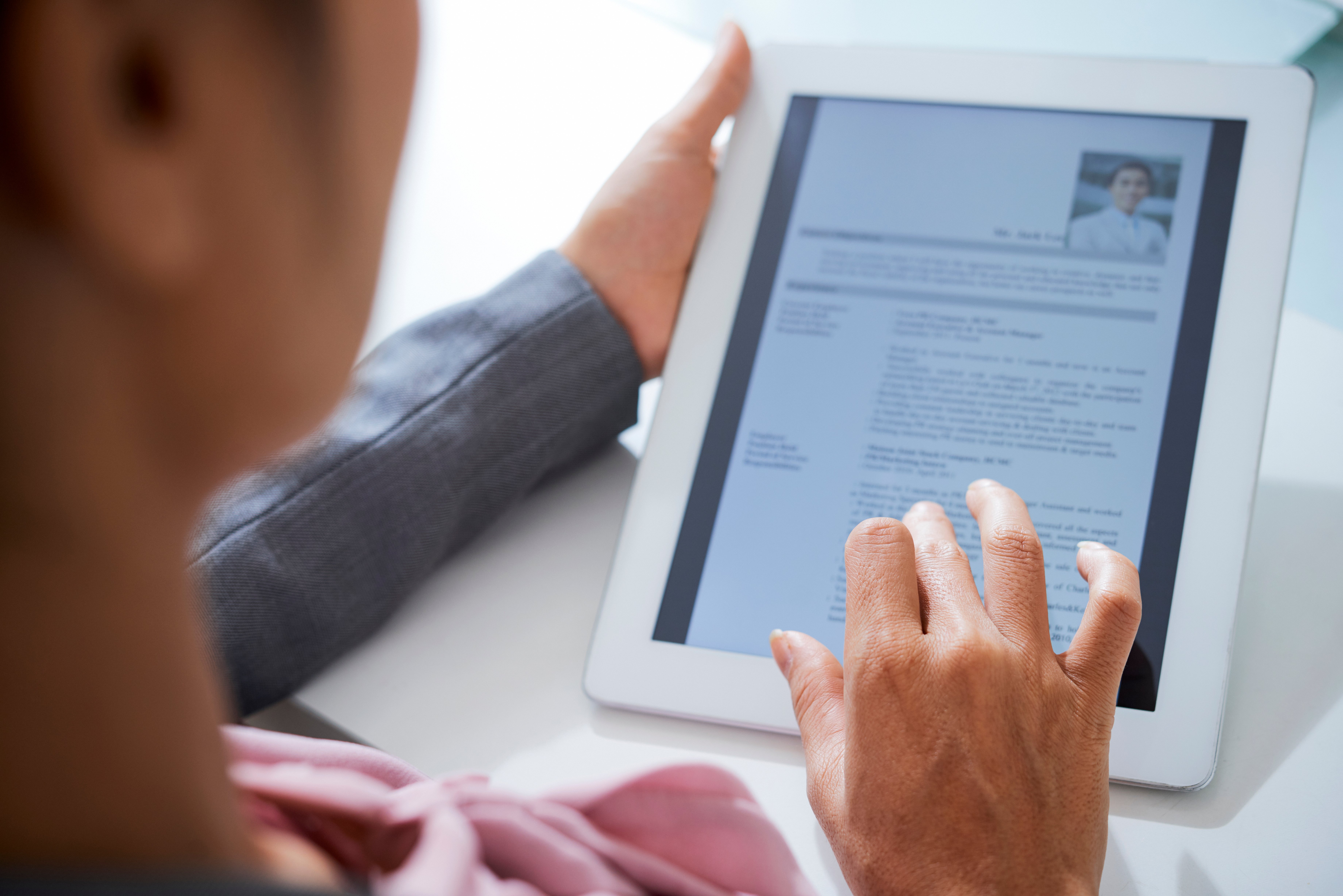 Someone looking through their CV on an I-pad