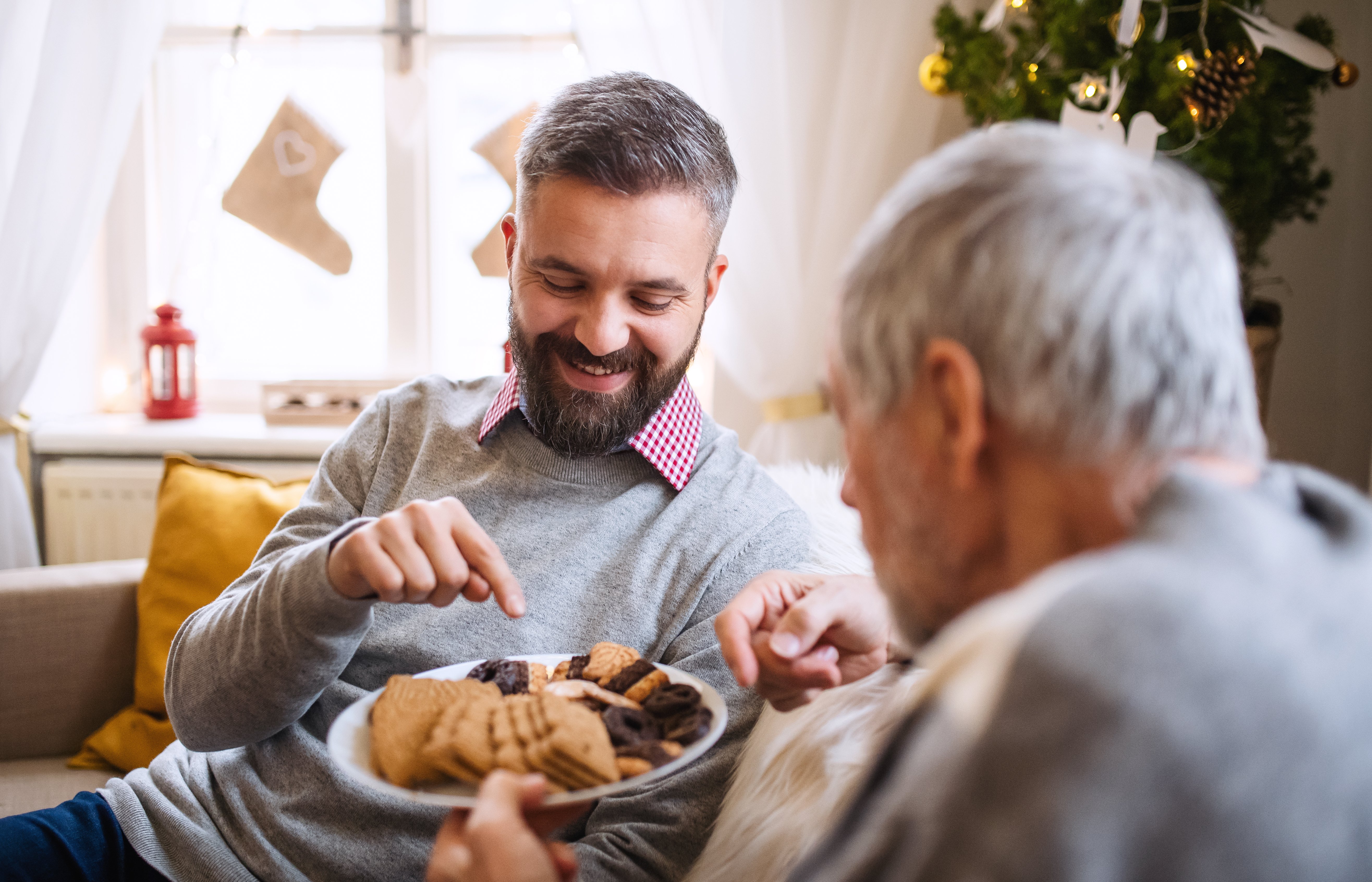 Picture from above illustrating two men sharing Christmas cookies