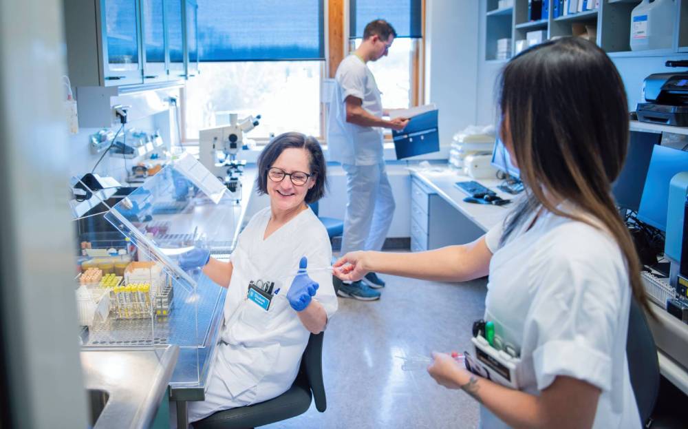 A group of bioengineers in a laboratory room.