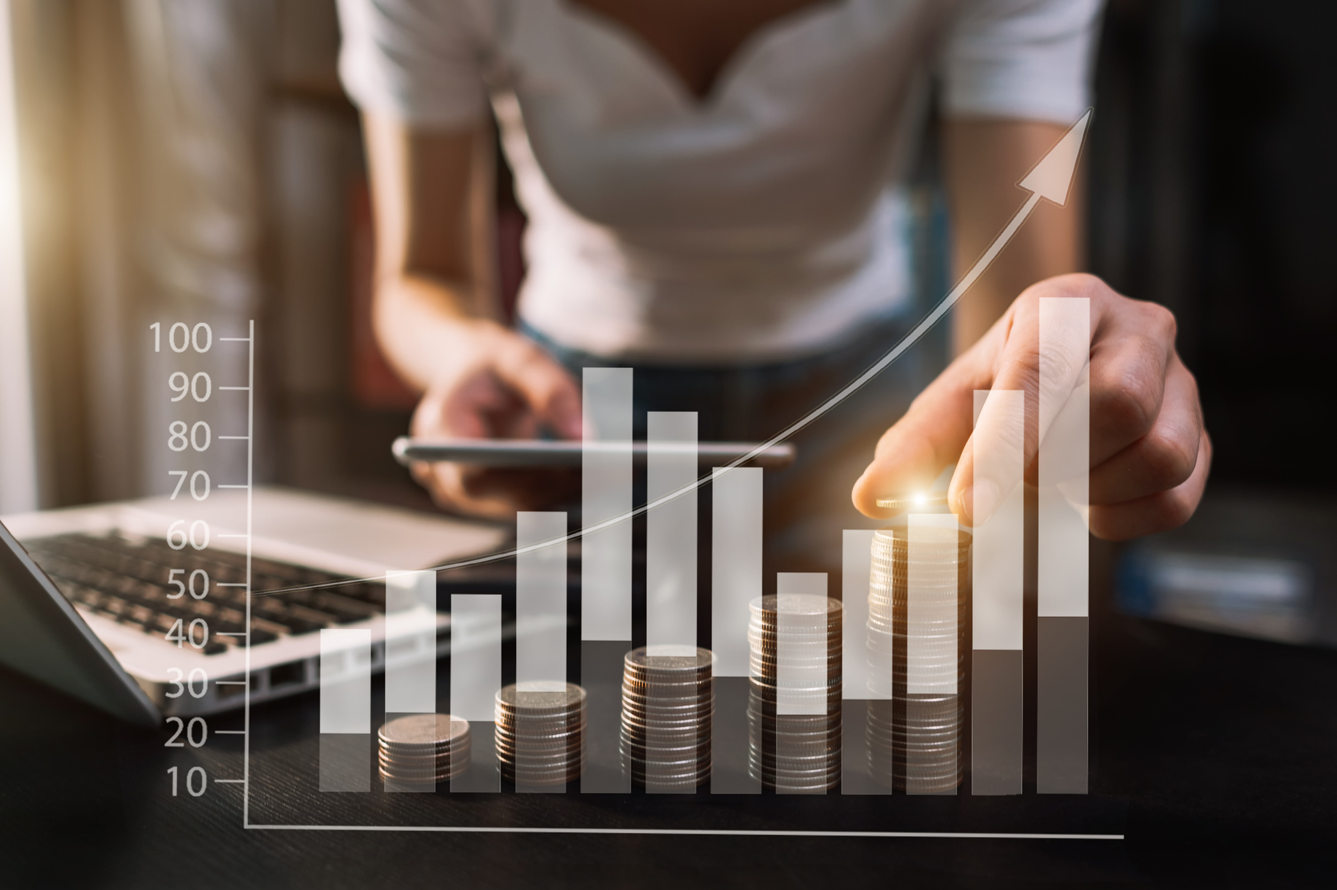 Woman stacking money into an upward chart. Photo: Getty Images