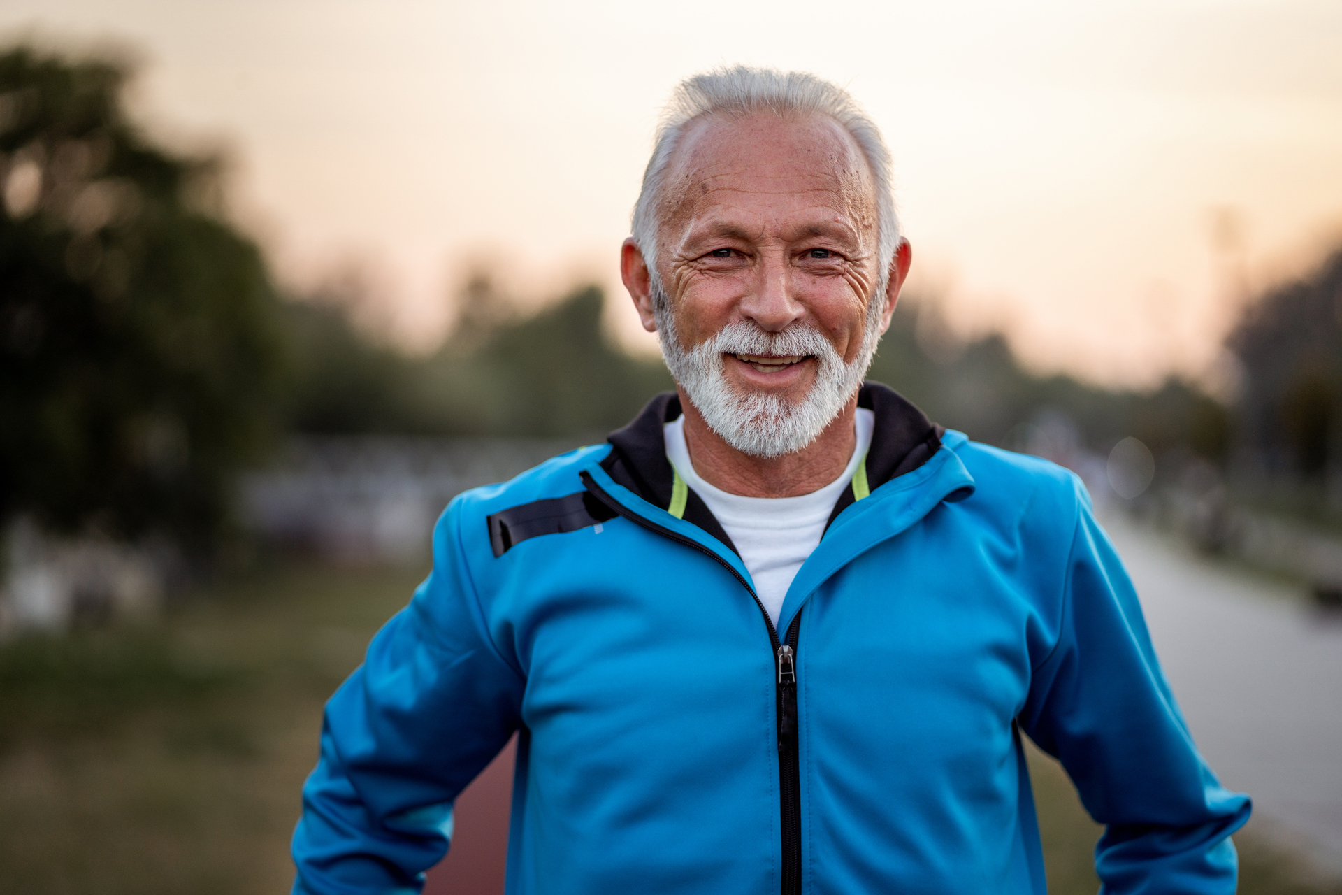 A grow older man who smiles at you.