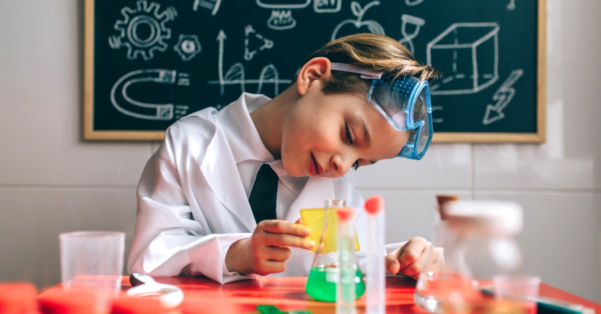 A boy in a lab coat researches at the research café