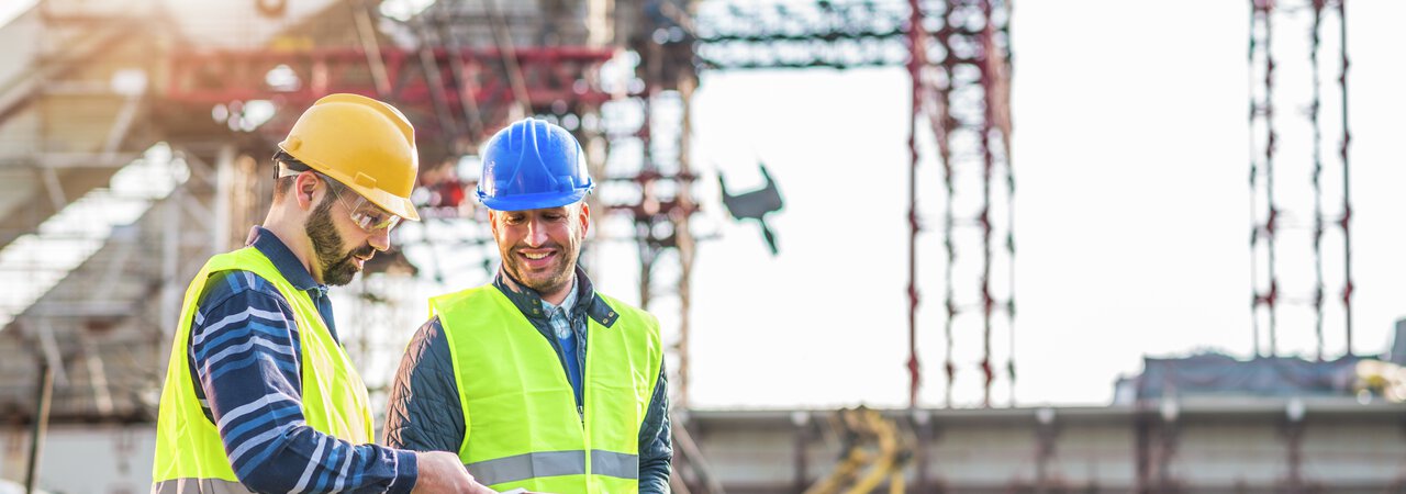 Photo: Gettyimages Two male engineers on a construction site