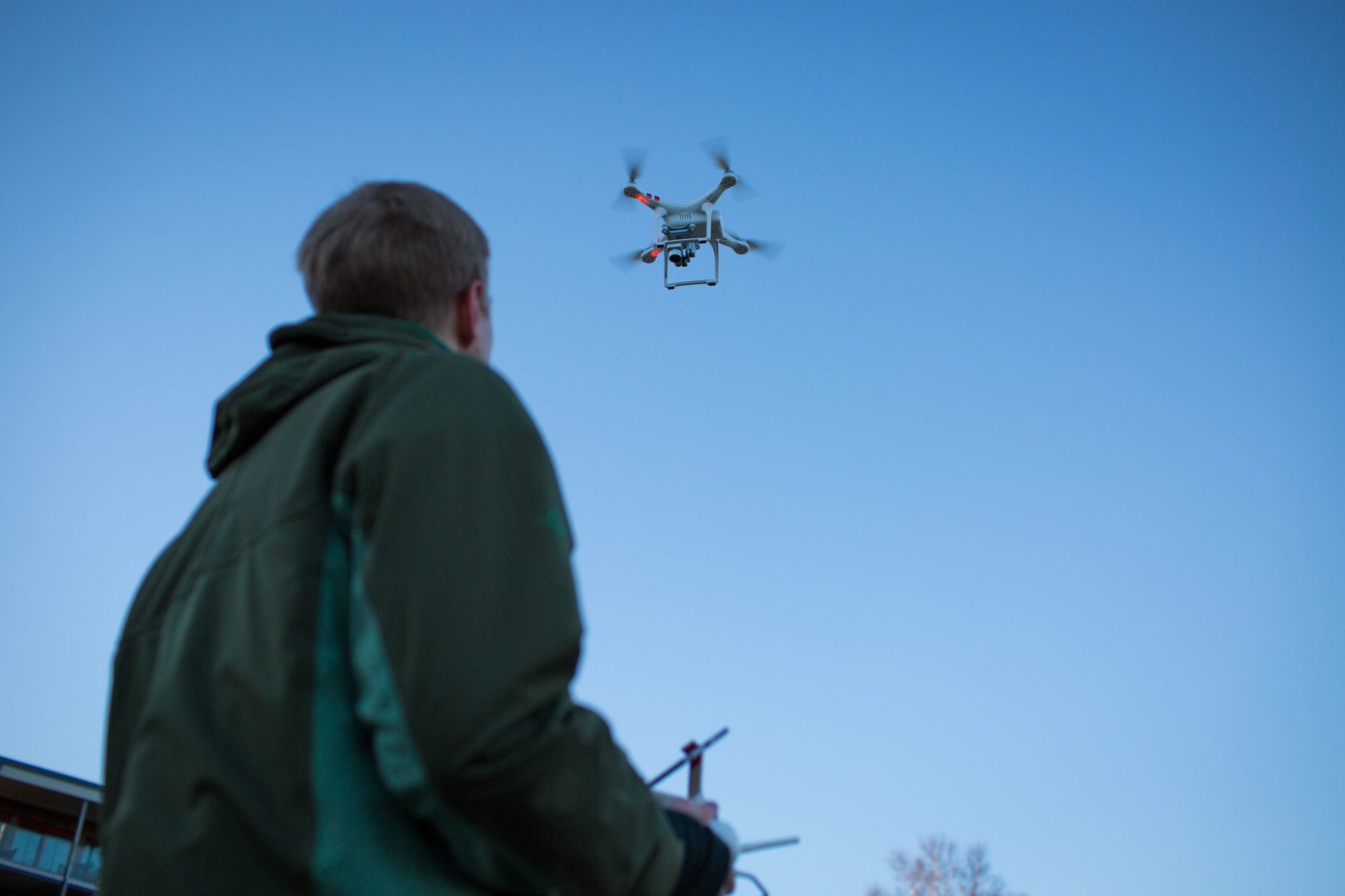 A young man flies a drone