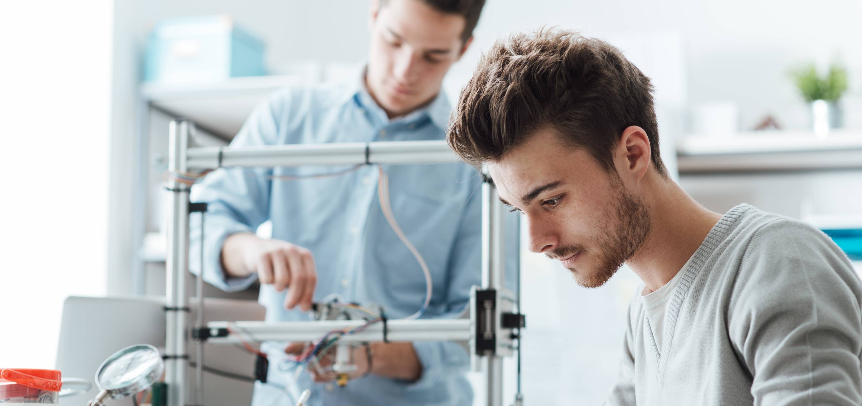 People sitting in a technical lab room and working together