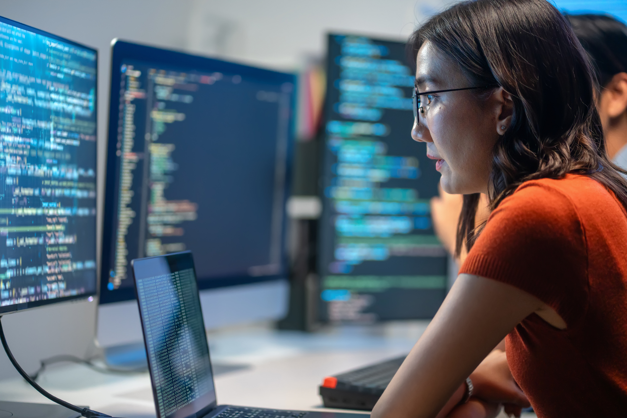 Female technologist analyzes data on a screen