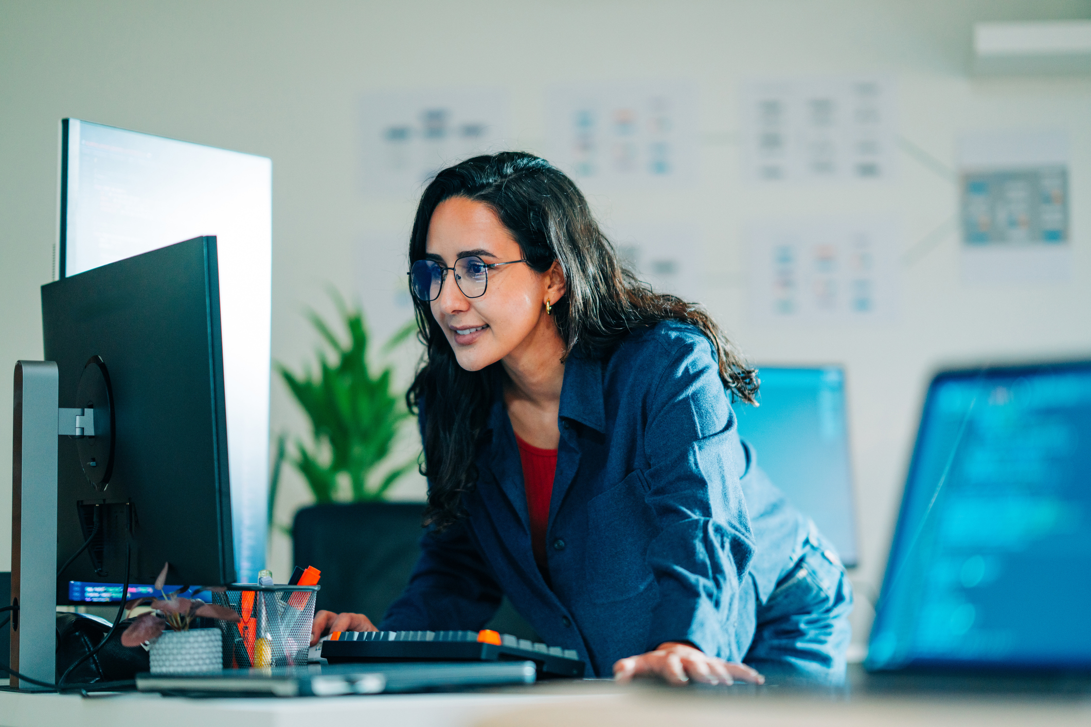 Woman looking at computer screen and smiling