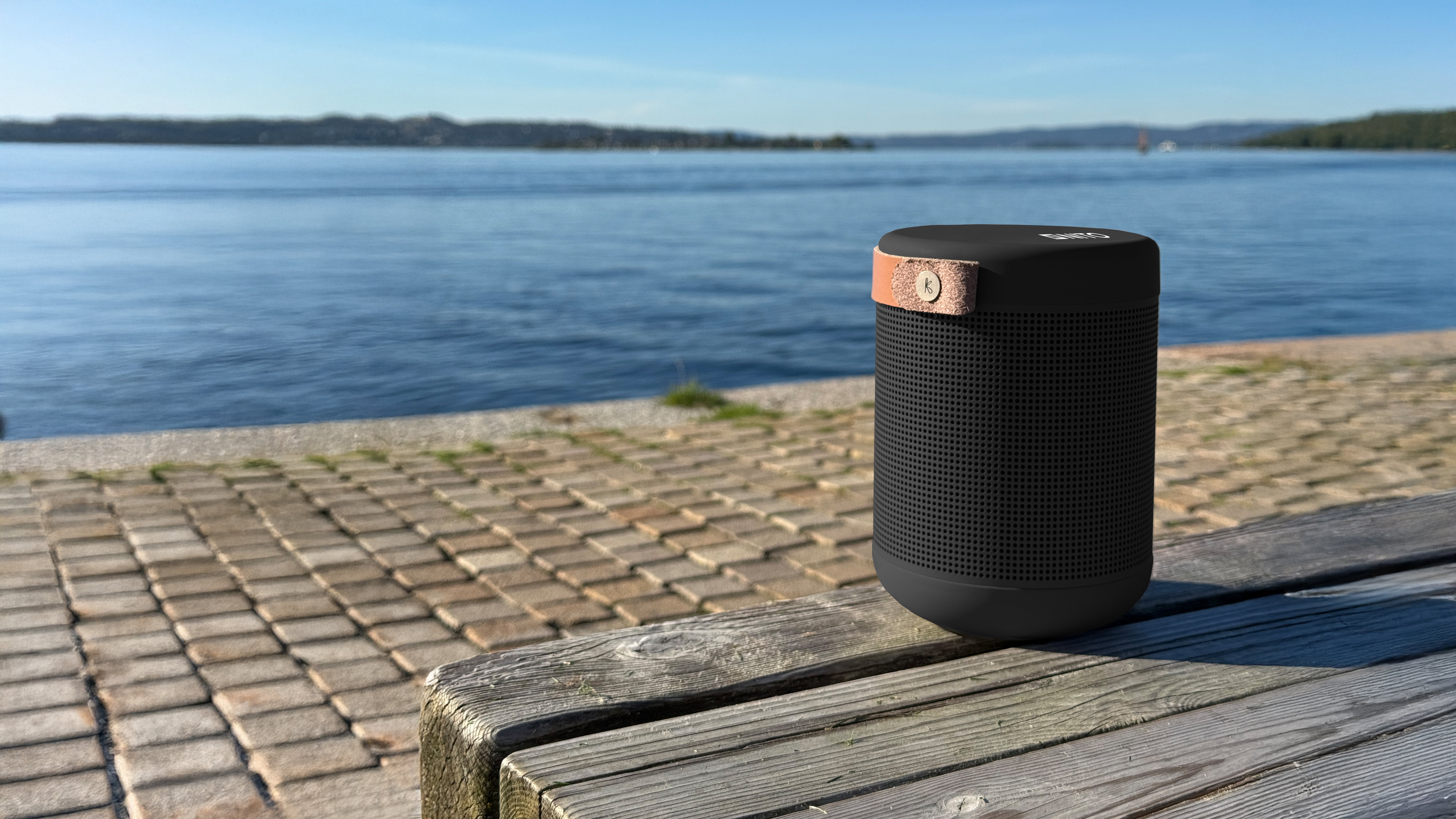 Kreafunk aMAJOR 2 høytaler på benk med vann i bakgrunnen